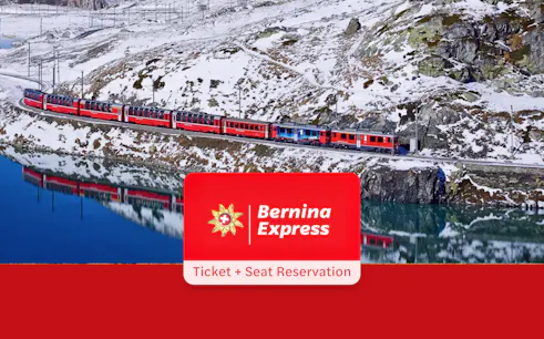 Bernina Express train traveling through snowy Alps near a reflective lake, Tirano to St. Moritz route.