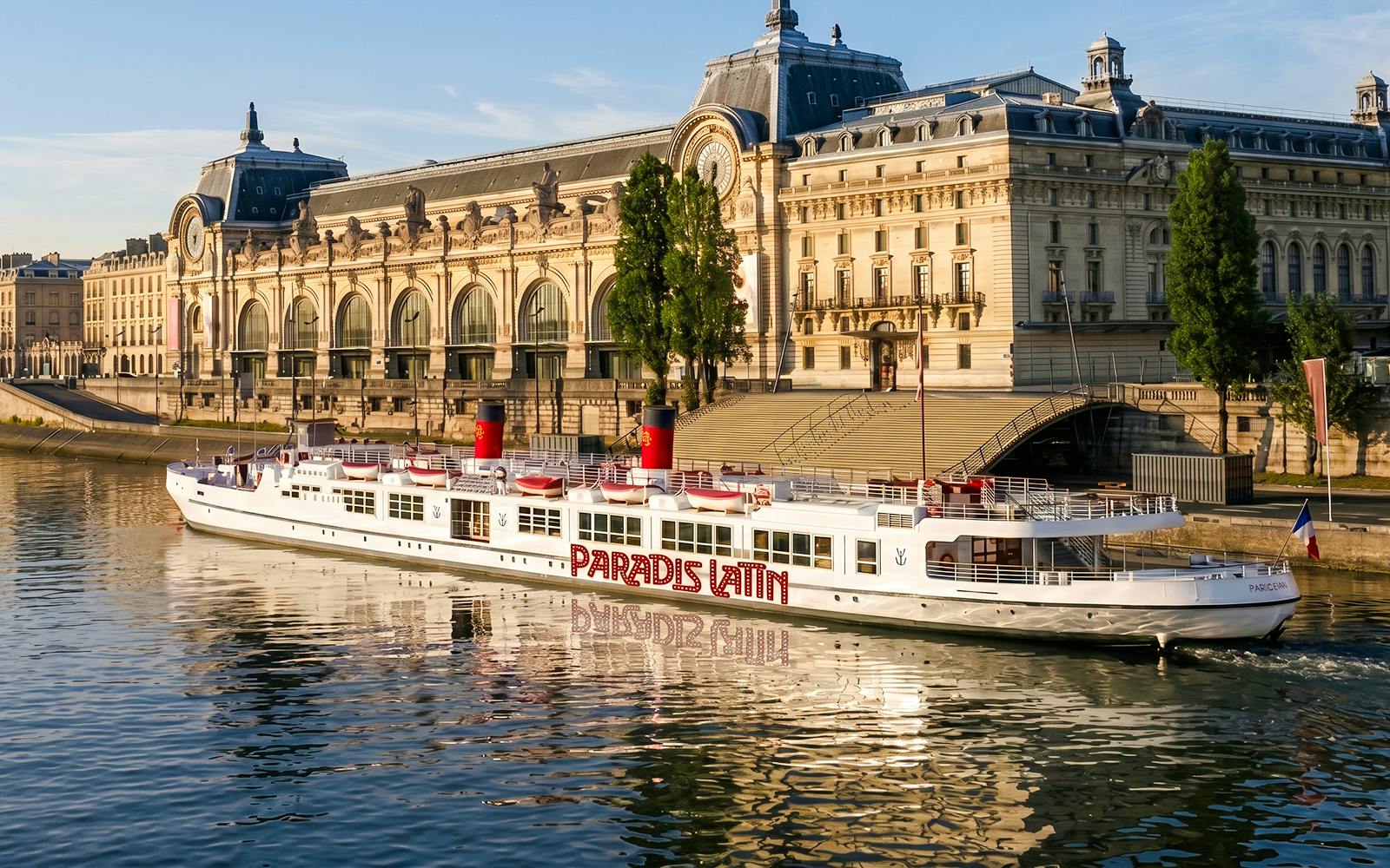 Dinner cruise boat on the Seine River in front of Musée d'Orsay, Paris.