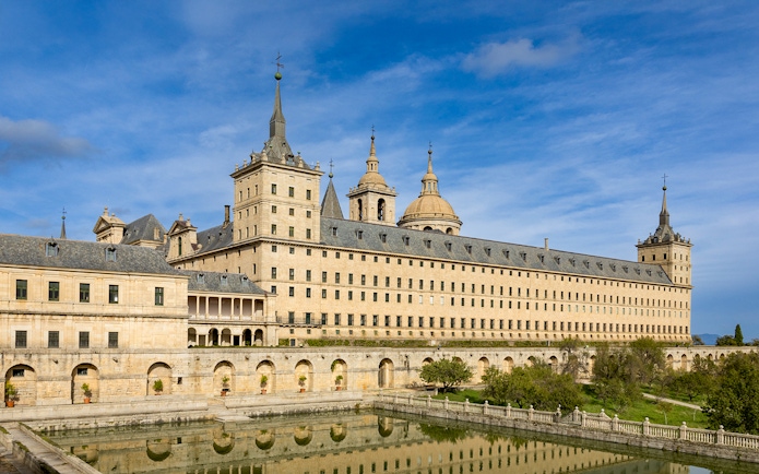 San Lorenzo de El Escorial monastery with reflection in pond, Spain.