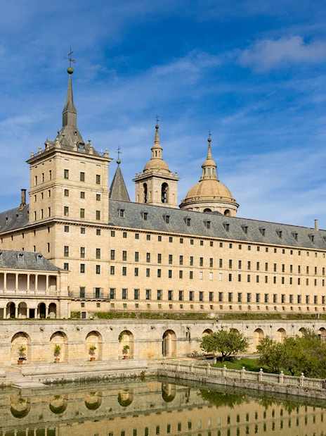 San Lorenzo de El Escorial monastery with reflection in pond, Spain.