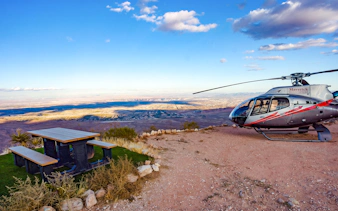 Helicopter on Red Rock Canyon overlook with view of Las Vegas skyline.