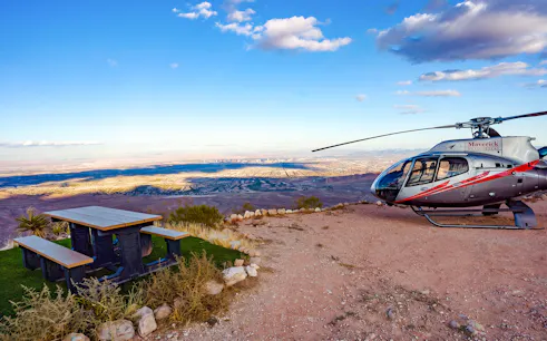 Helicopter on Red Rock Canyon overlook with view of Las Vegas skyline.