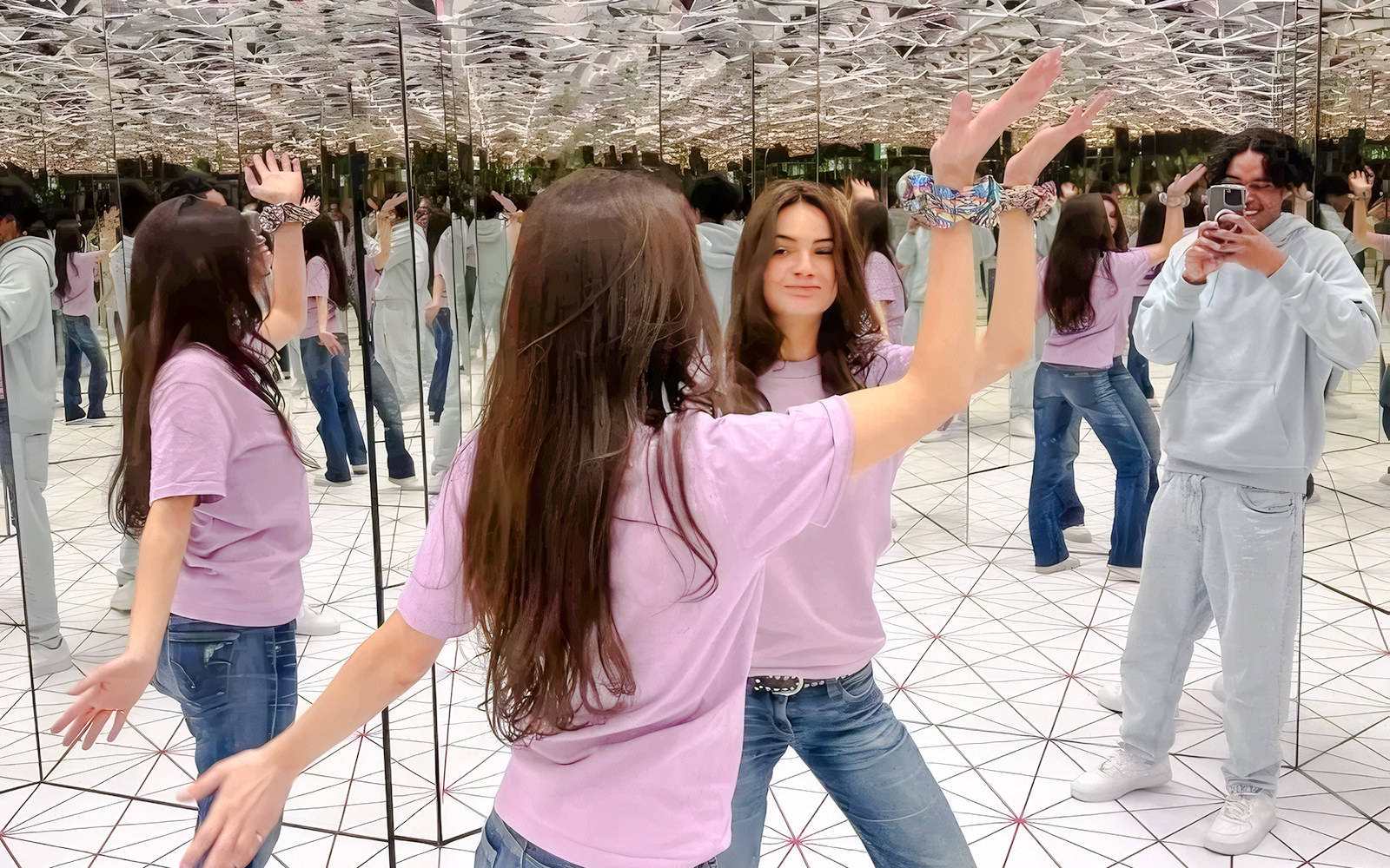 Visitors interacting in the infinity mirror room at Paradox Museum Paris.