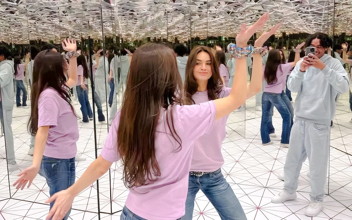 Visitors interacting in the infinity mirror room at Paradox Museum Paris.