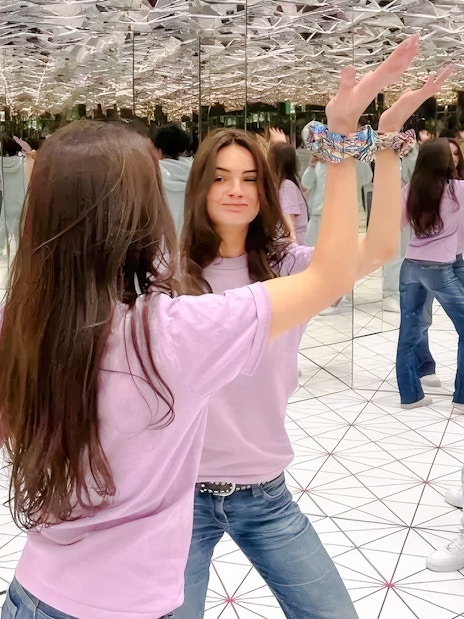Visitors interacting in the infinity mirror room at Paradox Museum Paris.