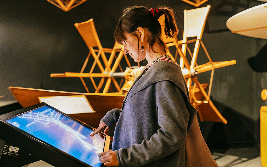 Visitor interacting with a touchscreen at Leonardo Interactive Museum, Florence.