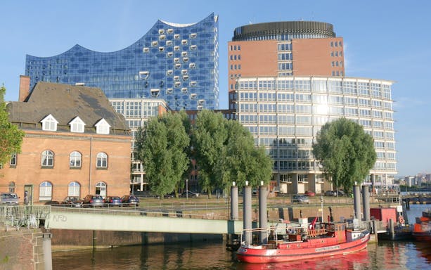 Elbphilharmonie Hamburg exterior with nearby buildings and river view.