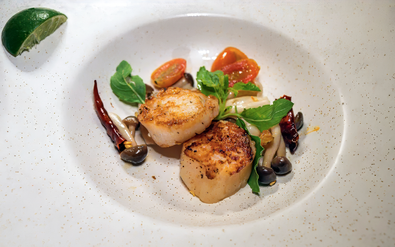 Seared scallops with vegetables on Saffron Luxury Cruise by Banyan Tree.