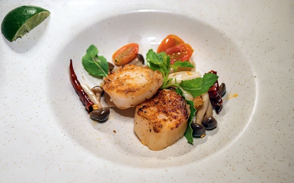 Seared scallops with vegetables on Saffron Luxury Cruise by Banyan Tree.