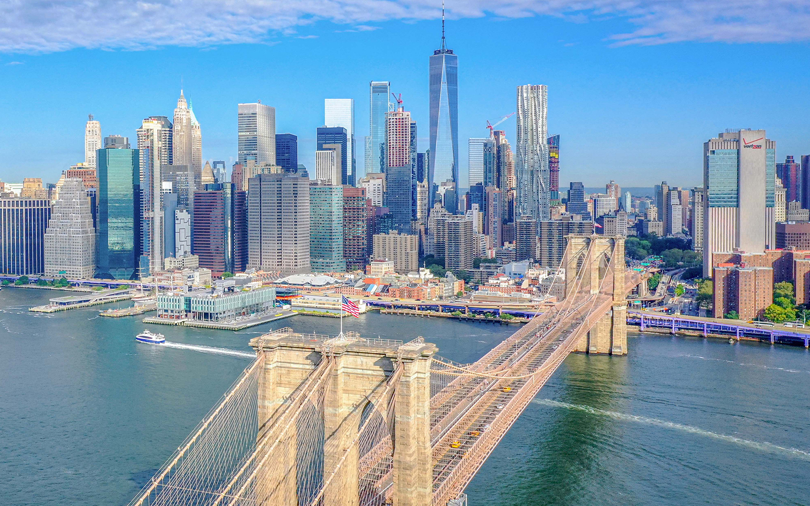 Aerial view of Brooklyn Bridge and Manhattan skyline during NYC helicopter tour.