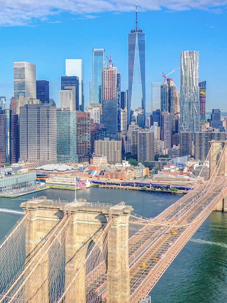 Aerial view of Brooklyn Bridge and Manhattan skyline during NYC helicopter tour.