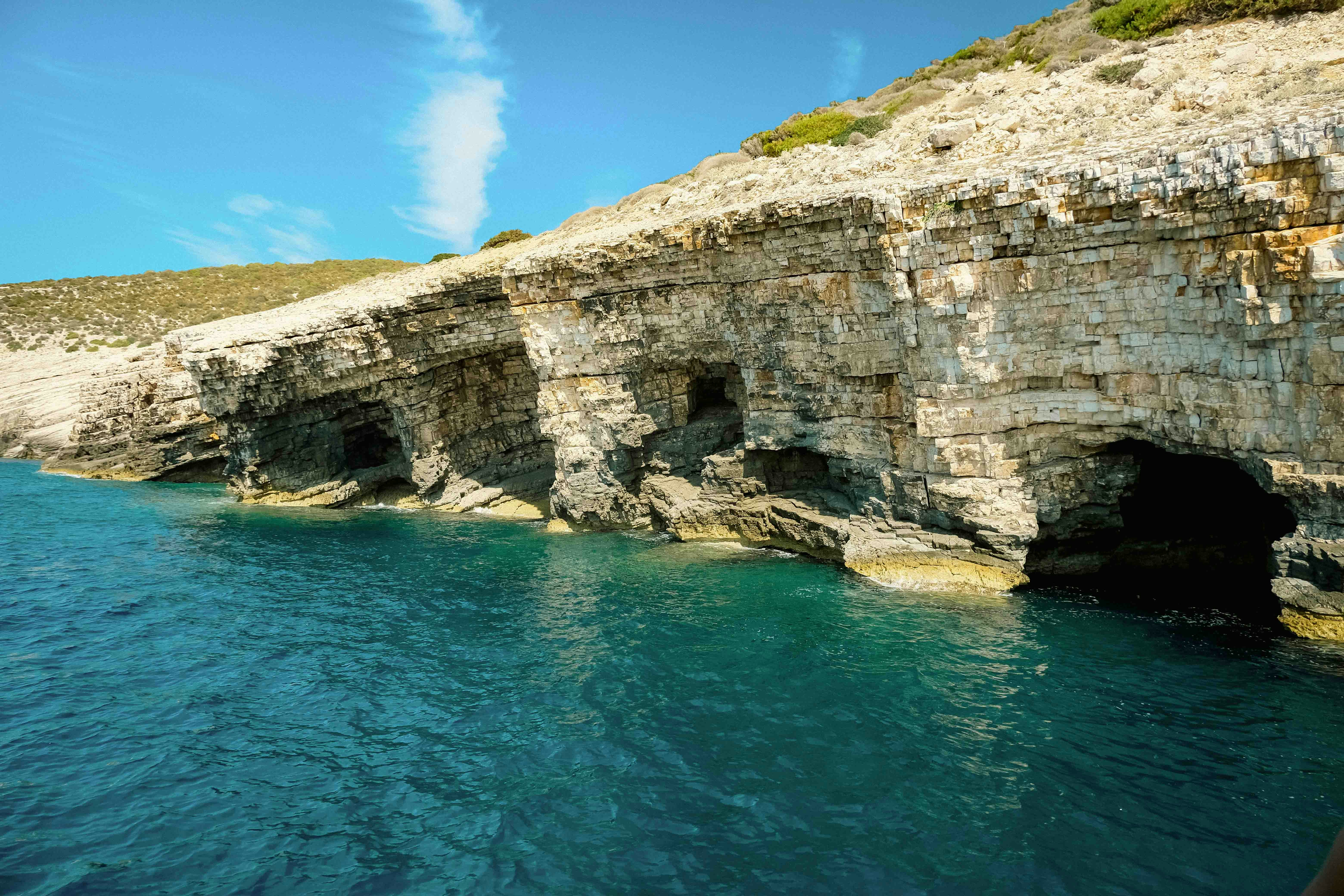 Coastal caves along the rocky shoreline of Biševo Island, Croatia.