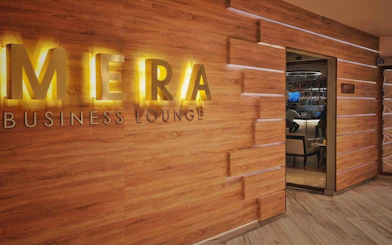 Mera VIP Lounge entrance at Cancun International Airport with wooden decor.