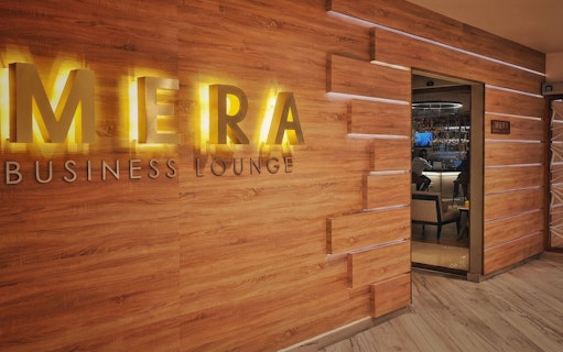 Mera VIP Lounge entrance at Cancun International Airport with wooden decor.