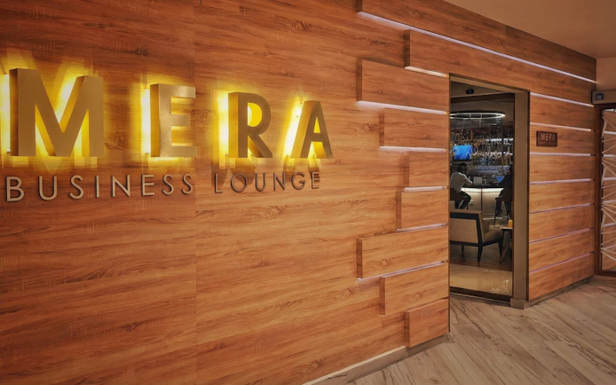 Mera VIP Lounge entrance at Cancun International Airport with wooden decor.