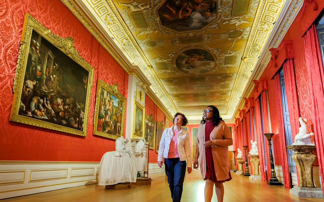 Visitors exploring art gallery at Kensington Palace, London.