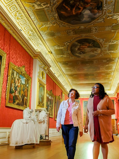 Visitors exploring art gallery at Kensington Palace, London.