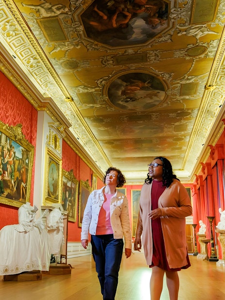 Visitors exploring art gallery at Kensington Palace, London.