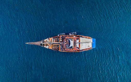 Aerial view of a pirate-themed dinner cruise ship on open water.