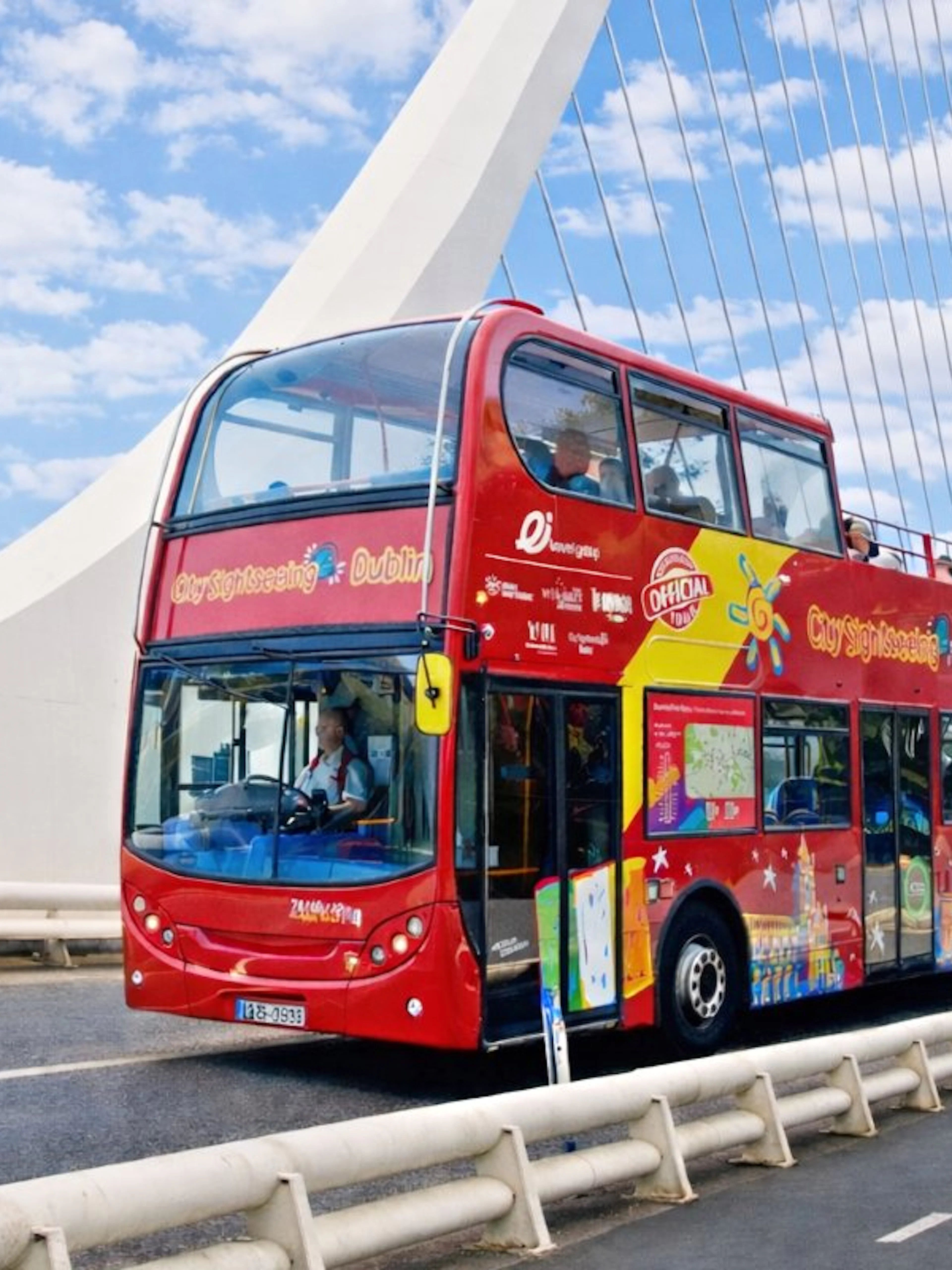 Open-top tour bus crossing Samuel Beckett Bridge in Dublin.