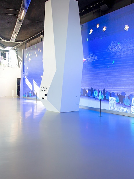 Main entrance of Remastered Rotterdam with digital art display.