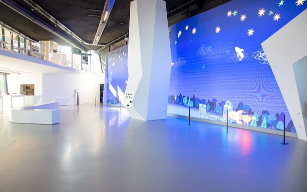 Main entrance of Remastered Rotterdam with digital art display.