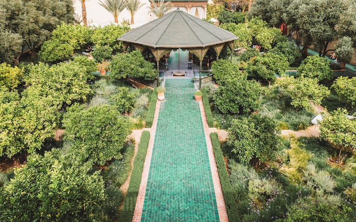 Jardin Secret garden with pavilion and green pathway in Marrakech, Morocco.