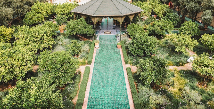 Jardin Secret garden with pavilion and green pathway in Marrakech, Morocco.