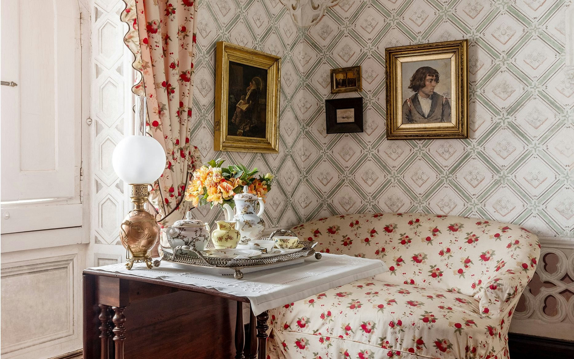 Dressing Room of Queen Amélia at Pena Palace, Sintra, featuring floral decor and vintage furnishings.