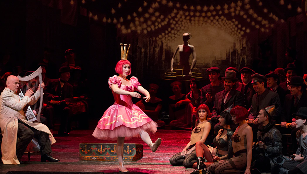 Performer in pink costume dances on stage during Les Contes d'Hoffmann opera.