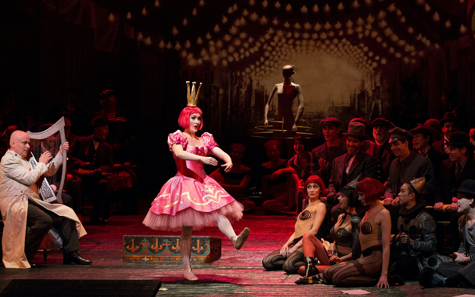 Performer in pink costume dances on stage during Les Contes d'Hoffmann opera.