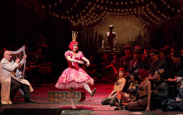 Performer in pink costume dances on stage during Les Contes d'Hoffmann opera.