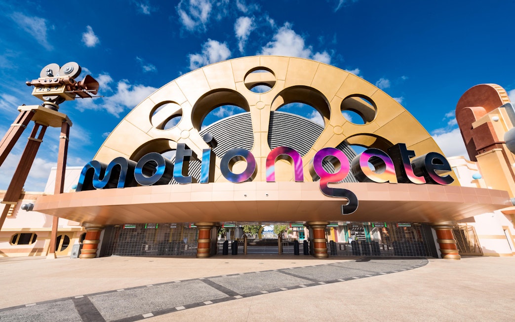 Entrance to MOTIONGATE Dubai with large film reel and camera structures.