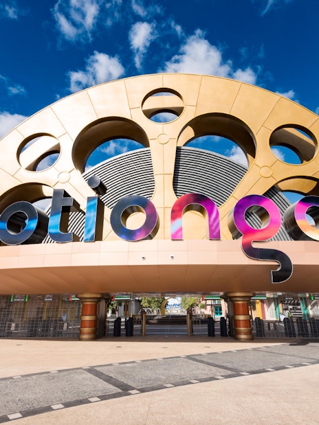 Entrance to MOTIONGATE Dubai with large film reel and camera structures.