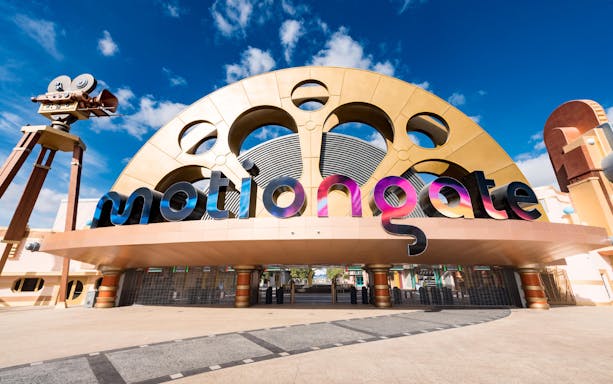 Entrance to MOTIONGATE Dubai with large film reel and camera structures.