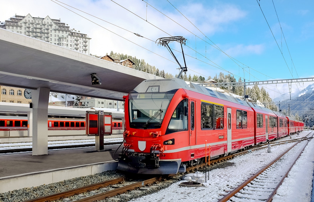 Bernina Express waiting for passengers at St Moritz Station during winters