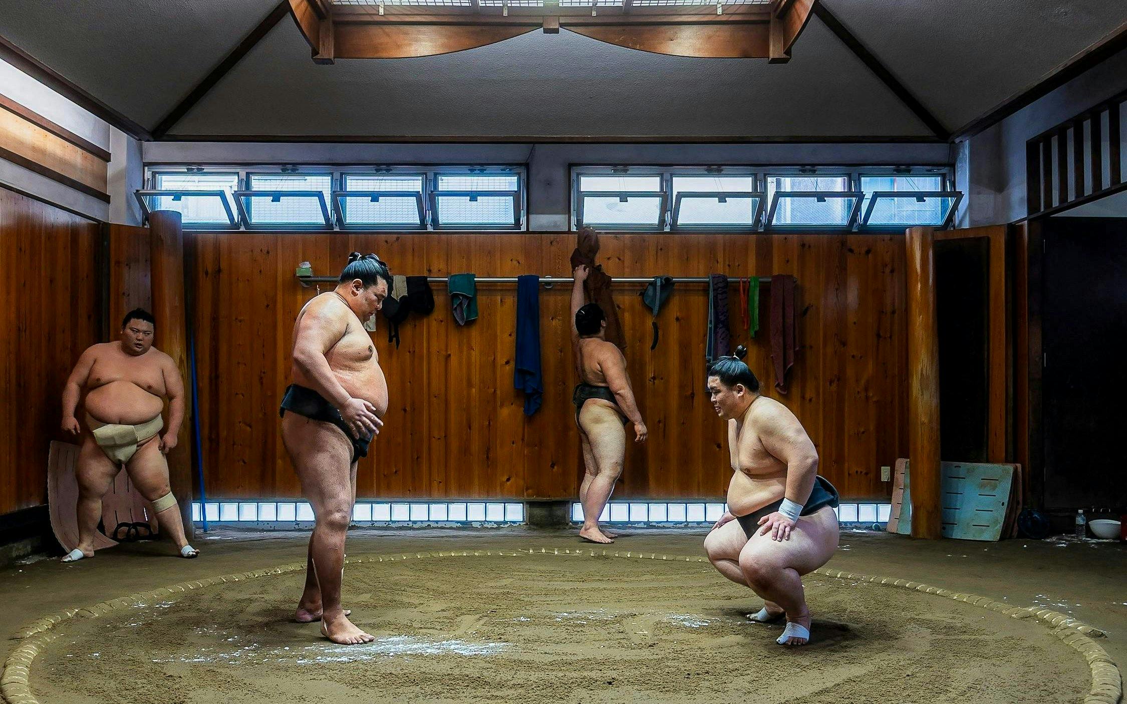 Sumo wrestlers practicing in a traditional dojo in Asakusa, Tokyo.