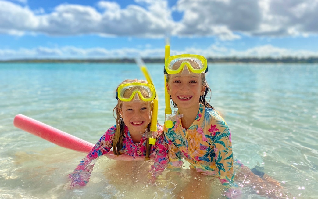Children snorkeling in clear waters on K'gari (Fraser Island) tour.
