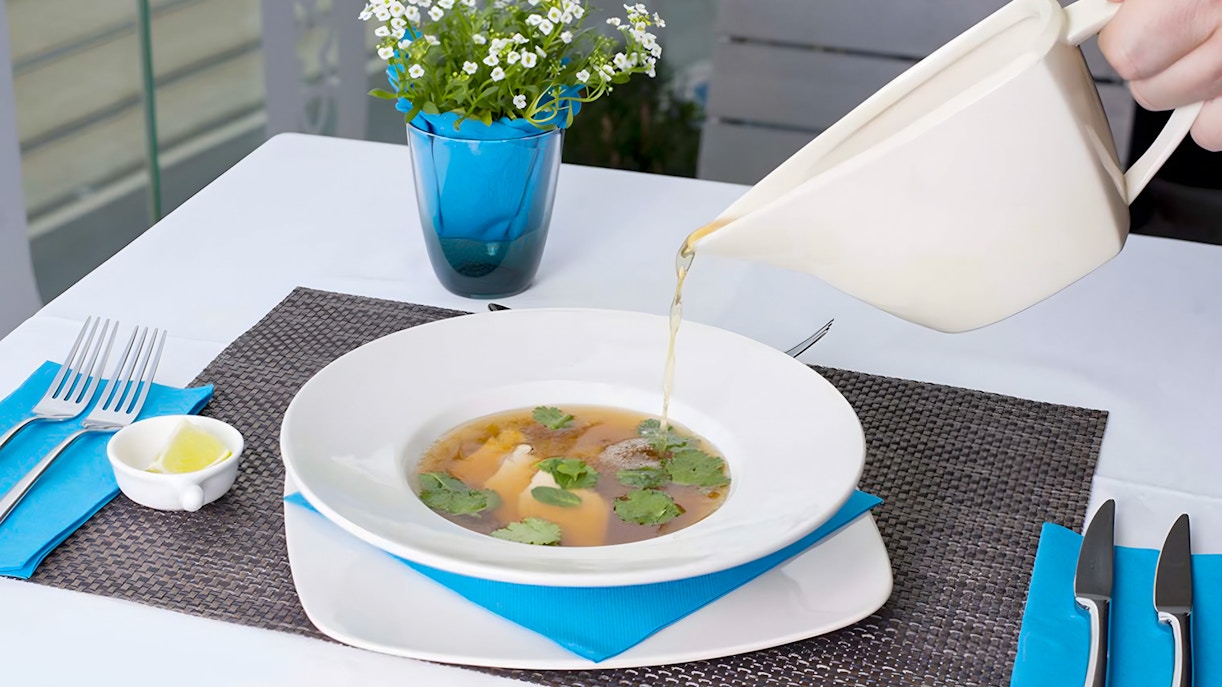 Indoor seating at a restaurant near Rudas Bath, featuring a sour dish on the table.