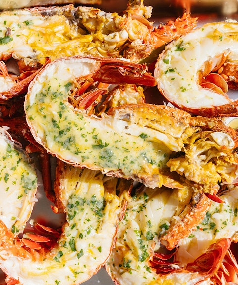 Grilled lobsters with herbs and butter on Rottnest Island Luxe Seafood Cruise.
