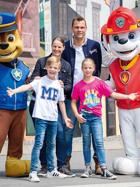 Family posing with PAW Patrol characters at Movie Park.