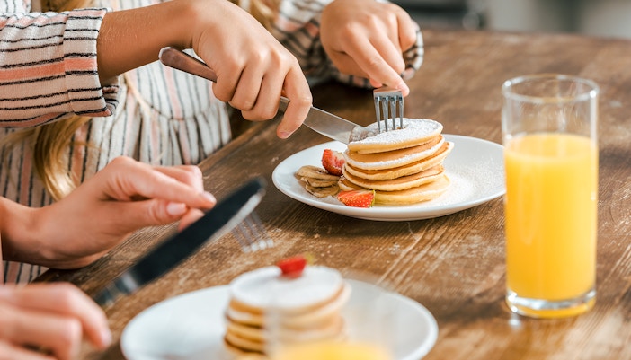 Close up view of pancakes stacked on top of each other on breakfast table