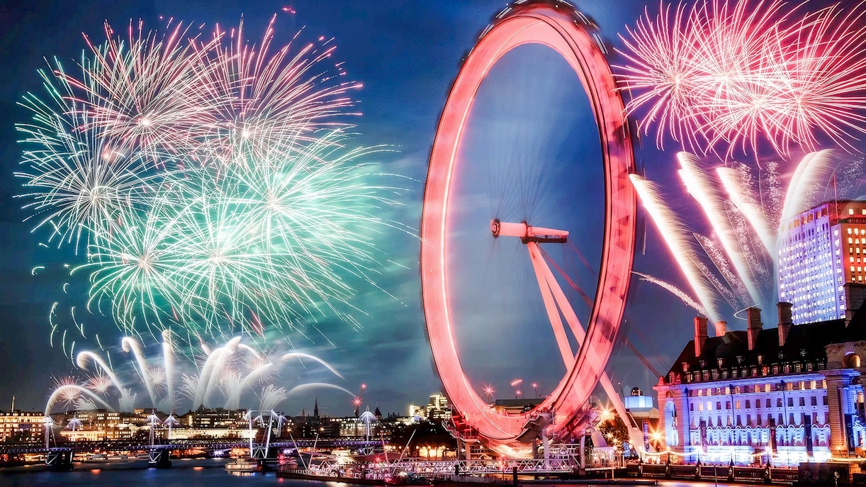 London Eye with fireworks display during New Year's celebration.