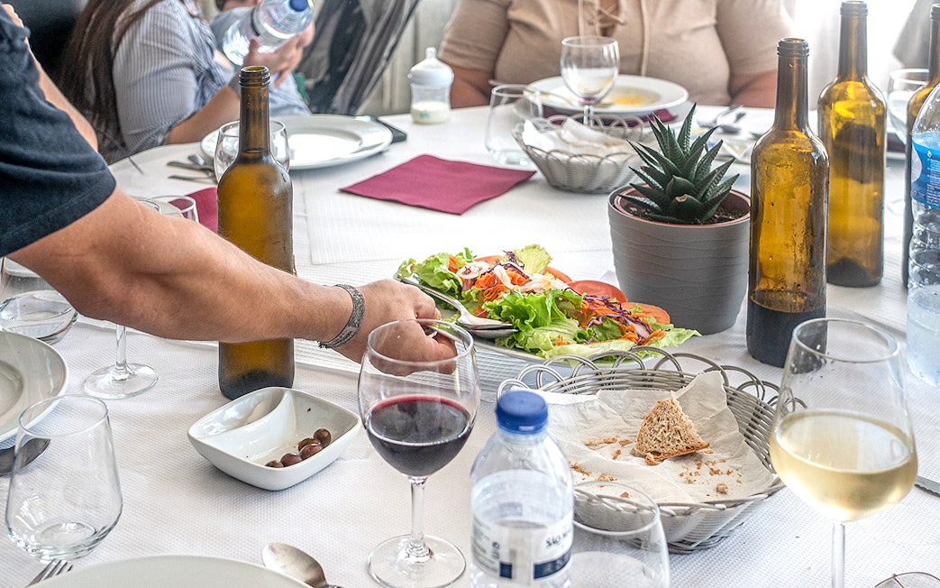 Lunch table with wine, salad, and bread during Douro Historical Tour from Porto.