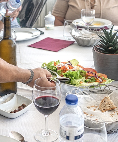 Lunch table with wine, salad, and bread during Douro Historical Tour from Porto.