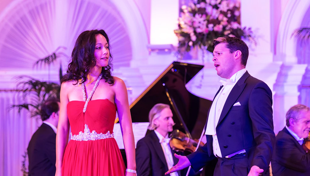 Performers at Mozart and Strauss concert in Kursalon Vienna with orchestra in background.