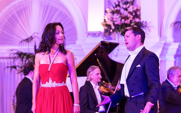 Performers at Mozart and Strauss concert in Kursalon Vienna with orchestra in background.