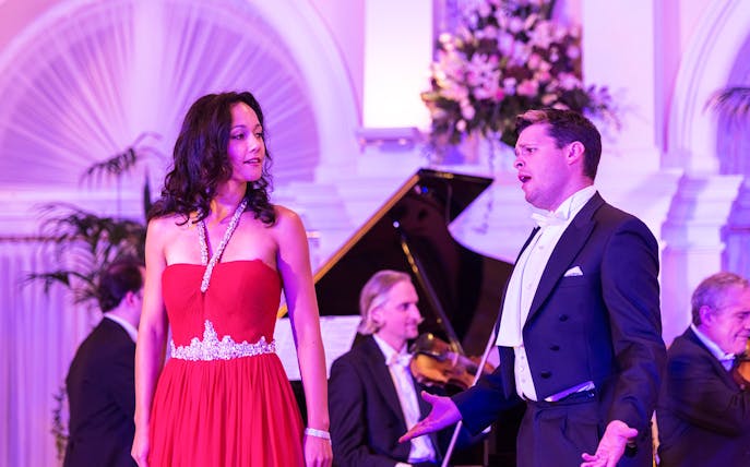 Performers at Mozart and Strauss concert in Kursalon Vienna with orchestra in background.