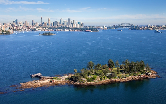 Shark Island with Sydney skyline and Harbour Bridge in the background during Captain Cook cruise.