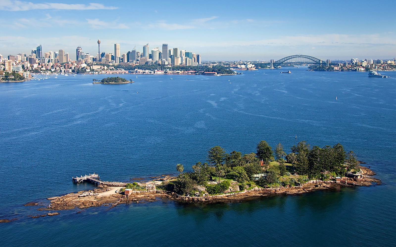 Shark Island with Sydney skyline and Harbour Bridge in the background during Captain Cook cruise.